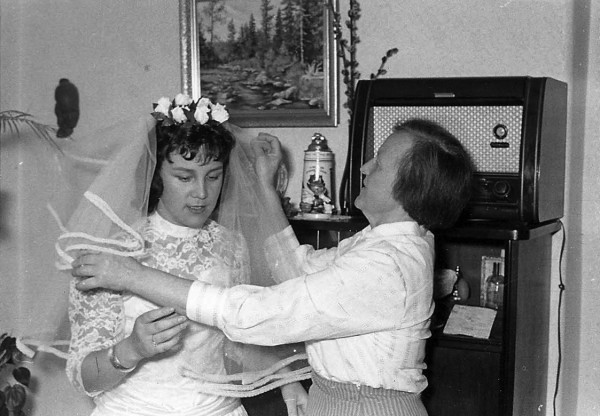 A painting that John Baker of Fort Kent gave to Philomena Baker to help her envision the beauty of Maine hangs on the wall as her mother, Philomene Keller, helps her prepare for her wedding on Aug. 12, 1959, in Amberg, Germany. A painting that John Baker of Fort Kent gave to Philomena Baker to help her envision the beauty of Maine hangs on the wall as her mother, Philomene Keller, helps her prepare for her wedding on Aug. 12, 1959, in Amberg, Germany.