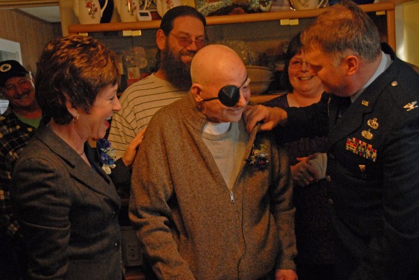 Retired U.S. Army Air Corps 1st Lieutenant Edwin Waite of Millinocket, 89, offers a shy smile as U.S. Air Force John Thomas, Commander at the Maine Air National Guard 101st Refueling Wing in Bangor, pins a Purple Heart on Waite's sweater during a brief ceremony in Millinocket on Thursday, Jan. 19. 2012. Retired U.S. Army Air Corps 1st Lieutenant Edwin Waite of Millinocket, 89, offers a shy smile as U.S. Air Force John Thomas, Commander at the Maine Air National Guard 101st Refueling Wing in Bangor, pins a Purple Heart on Waite's sweater during a brief ceremony in Millinocket on Thursday, Jan. 19. 2012.