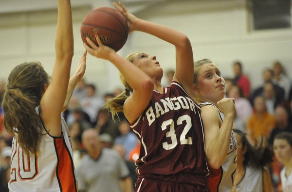 Bangor High School's Kayla Snow (32) puts up a shot with pressure from Brewer High School's Maddy Bailey (20) and Morgan Small during the first quarter of Tuesday night's Class A girls basketball prelim at Brewer High School. Bangor High School's Kayla Snow (32) puts up a shot with pressure from Brewer High School's Maddy Bailey (20) and Morgan Small during the first quarter of Tuesday night's Class A girls basketball prelim at Brewer High School.
