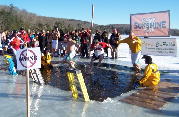 Chief Gary Parent of the Brewer Fire Department, in the middle wearing a Red Sox T-shirt, jumps into frozen cold Phillips Lake at the Camp CaPella Polar Plunge on Sunday, Feb. 5. Chief Gary Parent of the Brewer Fire Department, in the middle wearing a Red Sox T-shirt, jumps into frozen cold Phillips Lake at the Camp CaPella Polar Plunge on Sunday, Feb. 5.
