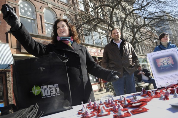 The Pulse (103.1 FM, 620 AM) Morning Show's Pat LaMarche (left) holds up a Hershey Kiss and she, radio co-host Don Cookson (center) and Mabel Wadsworth Women's Health Center education and outreach coordinator Abbie Strout (right) set up a booth in West Market Square in downtown Bangor to hand out some Valentine's Day freebies, including chocolate and condoms. The Pulse (103.1 FM, 620 AM) Morning Show's Pat LaMarche (left) holds up a Hershey Kiss and she, radio co-host Don Cookson (center) and Mabel Wadsworth Women's Health Center education and outreach coordinator Abbie Strout (right) set up a booth in West Market Square in downtown Bangor to hand out some Valentine's Day freebies, including chocolate and condoms.