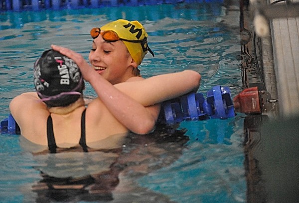 MDI High School's Leila Johnston (facing camera) congratulates Bangor High School's Mariah Reading after Johnston and Reading took first and second, respectively, in the fifth and final heat of the girls 200-yard IM finals during the 34th annual PVC Swimming and Diving Championships at Husson University on Saturday, Feb. 11, 2012. MDI High School's Leila Johnston (facing camera) congratulates Bangor High School's Mariah Reading after Johnston and Reading took first and second, respectively, in the fifth and final heat of the girls 200-yard IM finals during the 34th annual PVC Swimming and Diving Championships at Husson University on Saturday, Feb. 11, 2012.