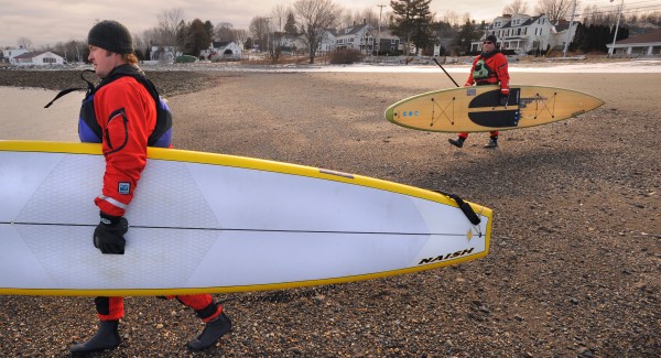 Thor Emory and Chris Laughlin carry their standup paddle boards to the water at Lincolnville beach in early February. The two avid paddlesports lovers are co-owners of Thorfinn Expeditions that offers sailing, kayaking and paddle boarding expeditions as well as accessories for the sports. During the off-season Emory and Laughlin often take a break from work and go for a paddle. Thor Emory and Chris Laughlin carry their standup paddle boards to the water at Lincolnville beach in early February. The two avid paddlesports lovers are co-owners of Thorfinn Expeditions that offers sailing, kayaking and paddle boarding expeditions as well as accessories for the sports. During the off-season Emory and Laughlin often take a break from work and go for a paddle.