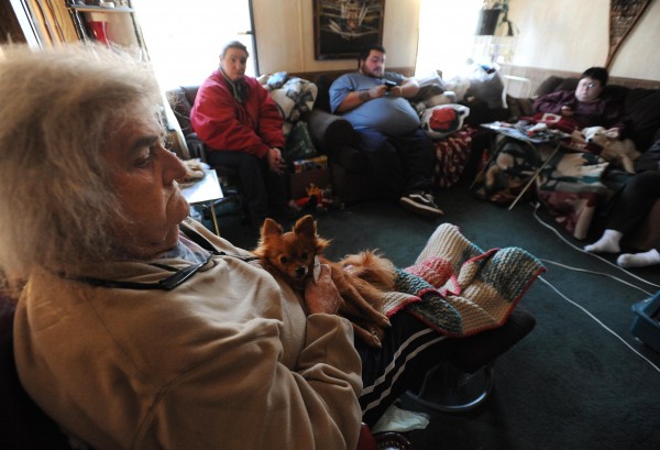 Eleanor Hartshorn sits with her dog Toby in a trailer owned by Patricia LeSan on on Thursday, Dec. 29, 2011. With her is Becky Nibby, second from left, Luman LeSan, center and his sister Betsy LeSan. Hartshorn was burned out of a mobile home she shared with Becky Nibby, Betsy LeSan and Pam Nibby. Eleanor Hartshorn sits with her dog Toby in a trailer owned by Patricia LeSan on on Thursday, Dec. 29, 2011. With her is Becky Nibby, second from left, Luman LeSan, center and his sister Betsy LeSan. Hartshorn was burned out of a mobile home she shared with Becky Nibby, Betsy LeSan and Pam Nibby.