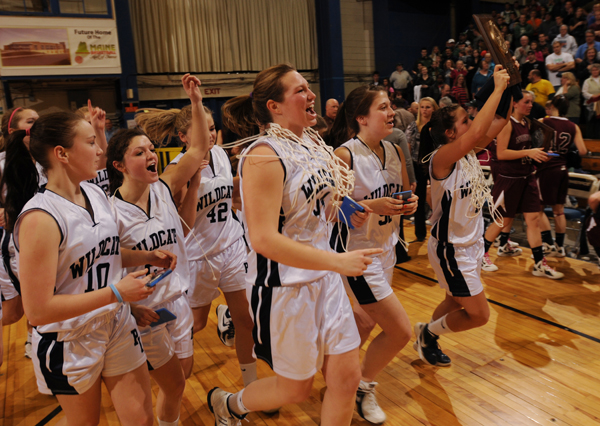 Members of the Presque Isle girls basketball team parade their Eastern Maine Class B trophy around the floor of the Bangor Auditorium on Saturday, Feb. 25, 2012 after defeating Nokomis. Members of the Presque Isle girls basketball team parade their Eastern Maine Class B trophy around the floor of the Bangor Auditorium on Saturday, Feb. 25, 2012 after defeating Nokomis.