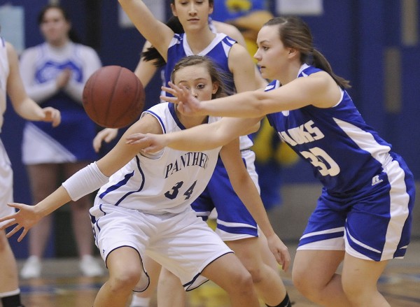 Hodgdon girls basketball player Mariah Wiley (30) dishes off under pressure from Central Aroostook girls player Victoria McIntyre (34) in the first half of their Class D playoff game in Bangor, Maine Thursday, Feb. 23, 2012. Hodgdon girls basketball player Mariah Wiley (30) dishes off under pressure from Central Aroostook girls player Victoria McIntyre (34) in the first half of their Class D playoff game in Bangor, Maine Thursday, Feb. 23, 2012.