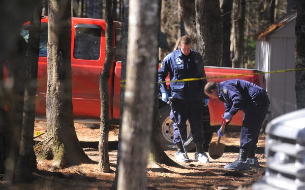 Maine State Police search the grounds for evidence with a metal detector on Monday, March 12, 2012 around the Lamoine home where four people were shot early Sunday morning. Maine State Police search the grounds for evidence with a metal detector on Monday, March 12, 2012 around the Lamoine home where four people were shot early Sunday morning.