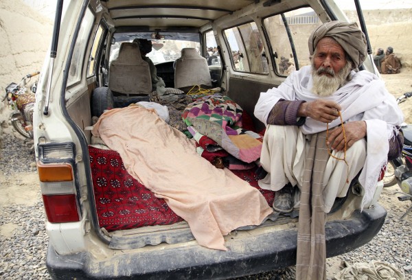 An elderly Afghan man sits next to the covered body of a person who was allegedly killed by a U.S. service member, in a minibus in Panjwai, Kandahar province south of Kabul, Afghanistan, Sunday, March 11, 2012. A U.S. service member walked out of a base in southern Afghanistan before dawn Sunday and started shooting Afghan civilians, according to villagers and Afghan and NATO officials. Villagers showed an Associated Press photographer 15 bodies, including women and children, and alleged they were killed by the American. An elderly Afghan man sits next to the covered body of a person who was allegedly killed by a U.S. service member, in a minibus in Panjwai, Kandahar province south of Kabul, Afghanistan, Sunday, March 11, 2012. A U.S. service member walked out of a base in southern Afghanistan before dawn Sunday and started shooting Afghan civilians, according to villagers and Afghan and NATO officials. Villagers showed an Associated Press photographer 15 bodies, including women and children, and alleged they were killed by the American.