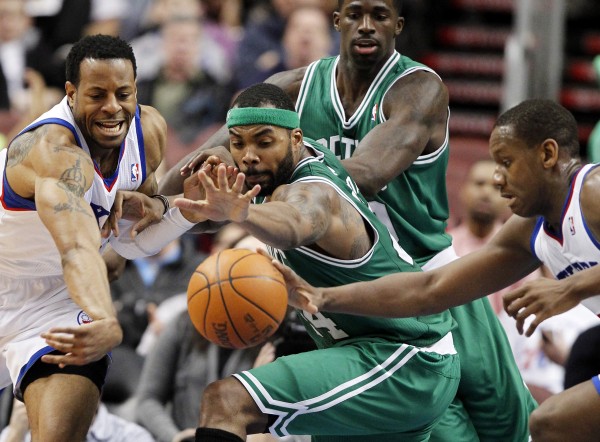 Philadelphia 76ers forward Andre Iguodala (left) and center Spencer Hawes (right) battle for a loose ball with Boston Celtics forward Chris Wilcox (center foreground) with Brandon Bass behind, during the first half of an NBA basketball game Wednesday, March 7, 2012 in Philadelphia. Philadelphia 76ers forward Andre Iguodala (left) and center Spencer Hawes (right) battle for a loose ball with Boston Celtics forward Chris Wilcox (center foreground) with Brandon Bass behind, during the first half of an NBA basketball game Wednesday, March 7, 2012 in Philadelphia.