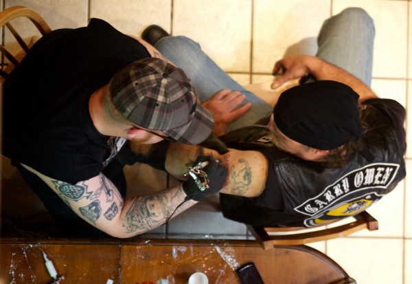 Curby Biagiotti of the Garry Owen Motorcycle Club gets the group's insignia tattooed on his arm in Chelsea Saturday afternoon, March 3, 2012, by an artist who asked not to be identified. Curby Biagiotti of the Garry Owen Motorcycle Club gets the group's insignia tattooed on his arm in Chelsea Saturday afternoon, March 3, 2012, by an artist who asked not to be identified.