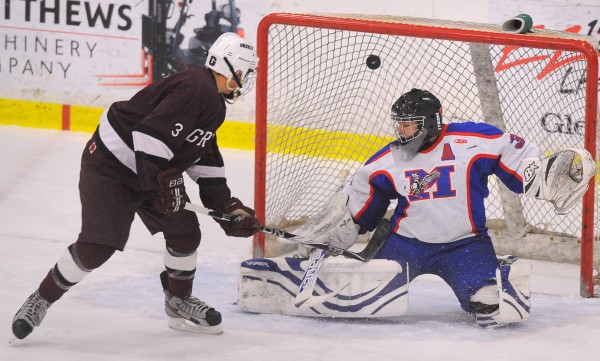 Greely High School's Ben Hackett (left) puts the puck in the net past Messalonskee High School's goalie Nathan DelGiudice. Hackett scored the team's second goal during the first period of the State Class B Championship game. Greely won the game 6-2. Greely High School's Ben Hackett (left) puts the puck in the net past Messalonskee High School's goalie Nathan DelGiudice. Hackett scored the team's second goal during the first period of the State Class B Championship game. Greely won the game 6-2.