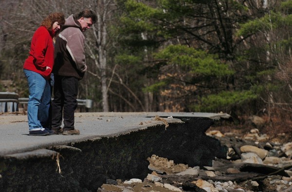 During a Saturday afternoon stroll, Kelly and Leon Licata of Orrington, who live on the nearby Blake Road, look over the newly formed precipice on the Swetts Pond Road created by Friday evening's dam breach in Orrington. Authorities attributed the flooding to a beaver dam which caused the evacuation of at least five households Friday night. Public safety and road crews worked through the night and continue to assess the erosion damage. During a Saturday afternoon stroll, Kelly and Leon Licata of Orrington, who live on the nearby Blake Road, look over the newly formed precipice on the Swetts Pond Road created by Friday evening's dam breach in Orrington. Authorities attributed the flooding to a beaver dam which caused the evacuation of at least five households Friday night. Public safety and road crews worked through the night and continue to assess the erosion damage.