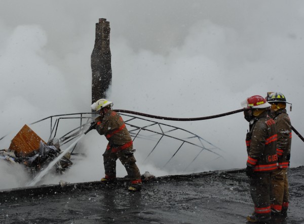 Members of the Fort Kent Volunteer Fire Department were at the scene of Sunday's blaze throughout the day hosing down hot spots and containing the fire that leveled three West Main Street buildings. Members of the Fort Kent Volunteer Fire Department were at the scene of Sunday's blaze throughout the day hosing down hot spots and containing the fire that leveled three West Main Street buildings.