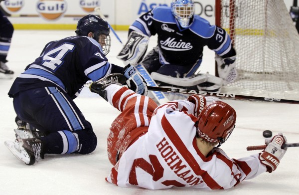 Boston University's Cason Hohmann (23) hits the ice trying to score as Maine's Ryan Hegarty (44) defends while goaltender Dan Sullivan (30) protects the net in the second period of an NCAA college Hockey East semifinal game in Boston on Friday, March 16, 2012. Boston University's Cason Hohmann (23) hits the ice trying to score as Maine's Ryan Hegarty (44) defends while goaltender Dan Sullivan (30) protects the net in the second period of an NCAA college Hockey East semifinal game in Boston on Friday, March 16, 2012.