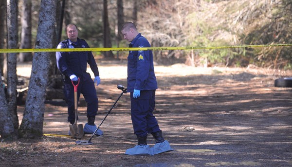 Maine State Police search the grounds for evidence with a metal detector Monday, March 12, 2012, around the Lamoine, Maine home where four people were shot Sunday morning. Maine State Police search the grounds for evidence with a metal detector Monday, March 12, 2012, around the Lamoine, Maine home where four people were shot Sunday morning.