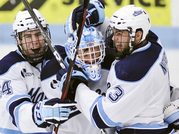 Maine goalie Dan Sullivan (30) celebrates with Ryan Hegarty (44) and Mark Nemec (3) after defeating Merrimack in a college hockey game on Sunday, March 11, 2012, in Orono. Maine goalie Dan Sullivan (30) celebrates with Ryan Hegarty (44) and Mark Nemec (3) after defeating Merrimack in a college hockey game on Sunday, March 11, 2012, in Orono.