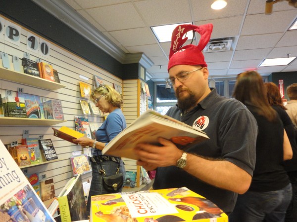 Chris Hourcle dons the red lobster hat and sticker prevalent among participants in Portland's first Cash Mob on Thursday, March 22, 2012. During the event, which was organized by Local Thunder, nearly 50 "mobbers" brought $20 each and raided Longfellow Books with business. Chris Hourcle dons the red lobster hat and sticker prevalent among participants in Portland's first Cash Mob on Thursday, March 22, 2012. During the event, which was organized by Local Thunder, nearly 50 "mobbers" brought $20 each and raided Longfellow Books with business.