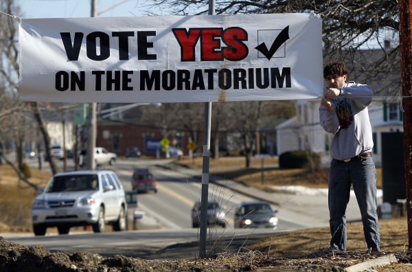 In this Friday, March 9, 2012 photo, Tim Sommer ties up a banner in opposition to a proposed 23-million gallon propane tank in Searsport, Maine. In this Friday, March 9, 2012 photo, Tim Sommer ties up a banner in opposition to a proposed 23-million gallon propane tank in Searsport, Maine.
