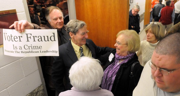 Phillip Merletti, the co-chair of the Republican Party in Lee, holds a sign as delegates leave a closed-door meeting of the Republican Party state commitee in Augusta on Saturday. Phillip Merletti, the co-chair of the Republican Party in Lee, holds a sign as delegates leave a closed-door meeting of the Republican Party state commitee in Augusta on Saturday.