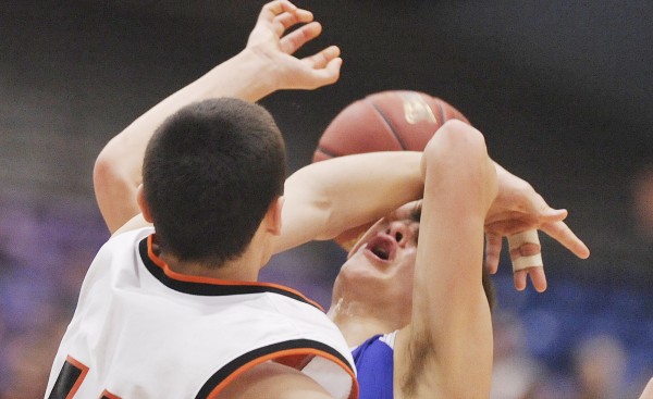 Jonesport-Beals boys basketball player Matthew Alley (right) gets fouled by Forest Hills player Matt Turner in the first half of their Class D championship game in Augusta Saturday, March 3, 2012. Jonesport-Beals boys basketball player Matthew Alley (right) gets fouled by Forest Hills player Matt Turner in the first half of their Class D championship game in Augusta Saturday, March 3, 2012.
