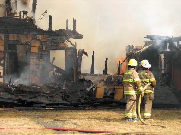 Trenton firefighters Joshua George and Steve Corson prepare to hose down burning remains of a house fire Monday morning at 698 Douglas Highway in the town of Lamoine. Trenton firefighters Joshua George and Steve Corson prepare to hose down burning remains of a house fire Monday morning at 698 Douglas Highway in the town of Lamoine.