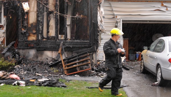 Edward Archer, senior investigator with the state fire marshal's office, takes pictures of a home in Brewer that caught on fire early Monday morning. Edward Archer, senior investigator with the state fire marshal's office, takes pictures of a home in Brewer that caught on fire early Monday morning.