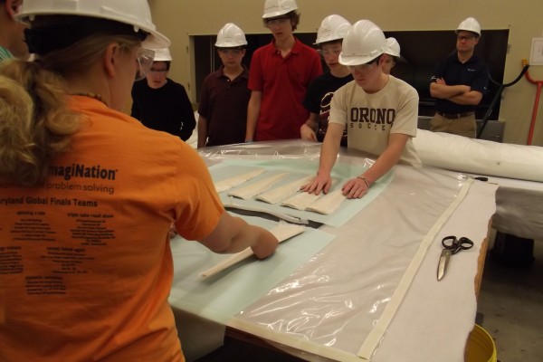 Orono High School students Emma Peterson (left) and Tyler Jewett (right) place model wind turbine blades on a layer of cloth and plastic as one of the first steps toward infusing and strengthening the blades with a resin in the Advanced Structures and Composites Center lab at the University of Maine in Orono on Wednesday, April 18, 2012. Two teams of students from Orono are preparing for a statewide competition scheduled for next week to see which school can produce the best and most efficient wind blade design. Orono High School students Emma Peterson (left) and Tyler Jewett (right) place model wind turbine blades on a layer of cloth and plastic as one of the first steps toward infusing and strengthening the blades with a resin in the Advanced Structures and Composites Center lab at the University of Maine in Orono on Wednesday, April 18, 2012. Two teams of students from Orono are preparing for a statewide competition scheduled for next week to see which school can produce the best and most efficient wind blade design.