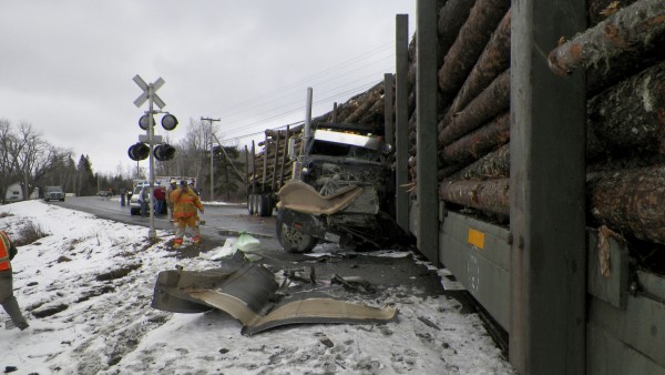 Travis Carll, 32, of Linneus suffered only a minor hand injury when his loaded log truck collided with a moving train also loaded with logs at about noon on Monday at a railroad crossing on Route 11 in Masardis, according to Maine State Police. Route 11 was closed for several hours as heavy equipment was brought in to clear the roadway. Travis Carll, 32, of Linneus suffered only a minor hand injury when his loaded log truck collided with a moving train also loaded with logs at about noon on Monday at a railroad crossing on Route 11 in Masardis, according to Maine State Police. Route 11 was closed for several hours as heavy equipment was brought in to clear the roadway.
