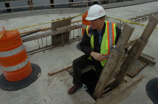 John Duncan, director of the Portland Area Comprehensive Transportation Committee, climbs out from the protected work and utility area hidden underneath the surface of the new Veterans Memorial Bridge, currently under construction. On Tuesday, April 10, 2012, members of the media and project stakeholders were given tours of the construction site to promote the summer opening. John Duncan, director of the Portland Area Comprehensive Transportation Committee, climbs out from the protected work and utility area hidden underneath the surface of the new Veterans Memorial Bridge, currently under construction. On Tuesday, April 10, 2012, members of the media and project stakeholders were given tours of the construction site to promote the summer opening.