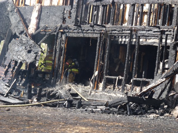 Firefighters secure the scene of a three-alarm fire in Topsham on Thursday, April 5, 2012. Firefighters secure the scene of a three-alarm fire in Topsham on Thursday, April 5, 2012.