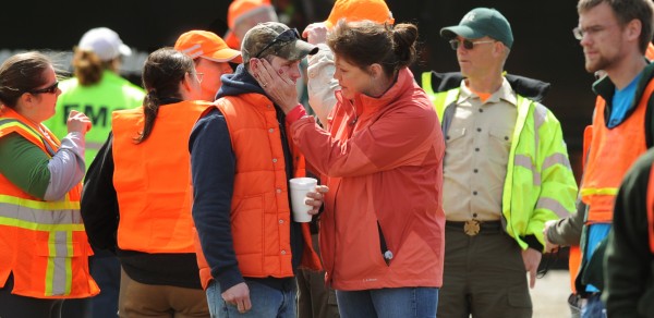 Volunteer searcher Cote Rossingnol is comforted by a woman on Wednesday, April 25, 2012 after searchers were briefed by game wardens and informed that the body of Dean Levasseur had been found in a dense area of woods not far from the point where he was last seen by band mate Josh Hunnefeld on Saturday, April 21, 2012 during the Chickenfest party in Howland. Volunteer searcher Cote Rossingnol is comforted by a woman on Wednesday, April 25, 2012 after searchers were briefed by game wardens and informed that the body of Dean Levasseur had been found in a dense area of woods not far from the point where he was last seen by band mate Josh Hunnefeld on Saturday, April 21, 2012 during the Chickenfest party in Howland.