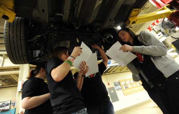 Female students from Brewer High School and Old Town High School try to identify automotive components from under a car at United Technologies Center in Bangor on Friday, April 6, 2012 during the 10th annual Totally Trades! conference. Female students from Brewer High School and Old Town High School try to identify automotive components from under a car at United Technologies Center in Bangor on Friday, April 6, 2012 during the 10th annual Totally Trades! conference.