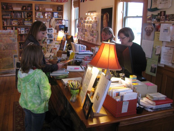 Gretchen Warsen of Nashua, N.H. makes a purchase at Left Bank Books Friday morning with her daughters Meredith, 9, and Millie, 6. Bookstore owners Lindsay McGuire (left) and Barbara Klausmeyer stand behind the counter of the crowded store, which will move to a new space on Church Street in Belfast in mid to late June. Gretchen Warsen of Nashua, N.H. makes a purchase at Left Bank Books Friday morning with her daughters Meredith, 9, and Millie, 6. Bookstore owners Lindsay McGuire (left) and Barbara Klausmeyer stand behind the counter of the crowded store, which will move to a new space on Church Street in Belfast in mid to late June.