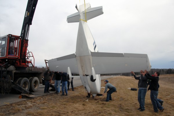 Several volunteers use a logging machine and some strapping to right a Glasair 1 airplane that went off the runway and nosed over at Lincoln Regional Airport on Sunday, April 1, 2012. Several volunteers use a logging machine and some strapping to right a Glasair 1 airplane that went off the runway and nosed over at Lincoln Regional Airport on Sunday, April 1, 2012.
