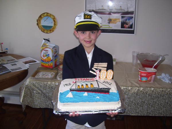 Nathan Carey, 8, dressed as the Titanic's Capt. Edward John Smith, holds a Titanic 100th anniversary cake at the party he arranged to commemorate the sinking of the great ship. Nathan Carey, 8, dressed as the Titanic's Capt. Edward John Smith, holds a Titanic 100th anniversary cake at the party he arranged to commemorate the sinking of the great ship.