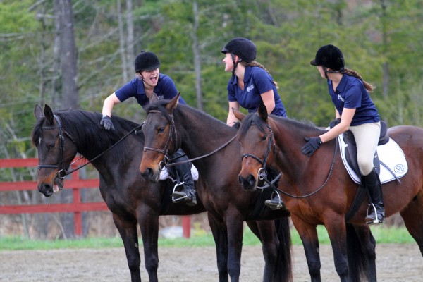 Arianna Goulatis (left), on Skittish, Erin Hediger, on Honor Society, and Rachel Keating, on Dorunbluefortunate, share a laugh during a drill team performance. Arianna Goulatis (left), on Skittish, Erin Hediger, on Honor Society, and Rachel Keating, on Dorunbluefortunate, share a laugh during a drill team performance.