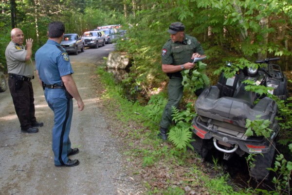 Penobscot County Sheriff's Deputy Mike Knights (left) discusses with Maine state Trooper Thomas Fiske (center) and Maine Game Warden Bruce Loring an ATV accident on a road off Madagascal Pond in Burlington on Saturday, May 26, 2012. Penobscot County Sheriff's Deputy Mike Knights (left) discusses with Maine state Trooper Thomas Fiske (center) and Maine Game Warden Bruce Loring an ATV accident on a road off Madagascal Pond in Burlington on Saturday, May 26, 2012.
