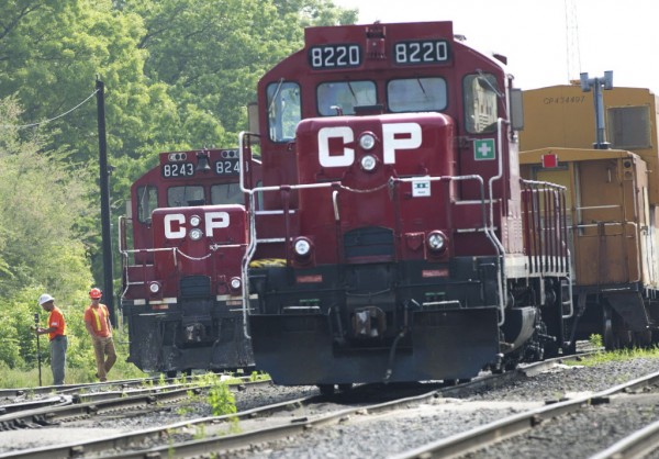 Surveyors work next to Canadian Pacific Rail trains which are parked on the train tracks in Toronto on Wednesday, May 23, 2012. Canada's labor minister said Wednesday the government will introduce legislation if necessary to end a strike at Canadian Pacific railway, which has forced the suspension of its freight service in Canada and the United States. Surveyors work next to Canadian Pacific Rail trains which are parked on the train tracks in Toronto on Wednesday, May 23, 2012. Canada's labor minister said Wednesday the government will introduce legislation if necessary to end a strike at Canadian Pacific railway, which has forced the suspension of its freight service in Canada and the United States.