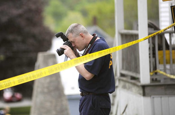 Herb Leighton of the Maine State Police photographs the scene of a stabbing on Howe Street in Lewiston on Sunday. Herb Leighton of the Maine State Police photographs the scene of a stabbing on Howe Street in Lewiston on Sunday.