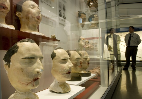 Tim Clarke Jr., deputy communications director at the National Museum of Health and Medicine in Silver Spring, Md., stands near a display of facial casts of Civil War combatants taken for surgeons who attempted reconstruction. Tim Clarke Jr., deputy communications director at the National Museum of Health and Medicine in Silver Spring, Md., stands near a display of facial casts of Civil War combatants taken for surgeons who attempted reconstruction.