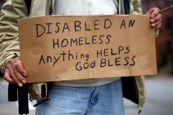 Don Deitz, 47, leans against a utility pole and holds his sign, waiting for a handout at the corner of State Street and Park Avenue in Portland. Don Deitz, 47, leans against a utility pole and holds his sign, waiting for a handout at the corner of State Street and Park Avenue in Portland.