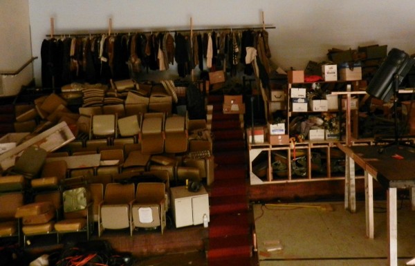 Rather than patrons, the Penobscot Theatre Company's balcony is filled with costumes and stacks of seats, piled up to make room for other items. Rather than patrons, the Penobscot Theatre Company's balcony is filled with costumes and stacks of seats, piled up to make room for other items.