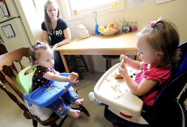 Teri Clavet feeds lunch to her twin 19-month-old daughters Salina Nichols, left, and Aliana Nichols at their central Maine apartment. Clavet, a single mom, also has a 7-year-old daughter. Teri Clavet feeds lunch to her twin 19-month-old daughters Salina Nichols, left, and Aliana Nichols at their central Maine apartment. Clavet, a single mom, also has a 7-year-old daughter.
