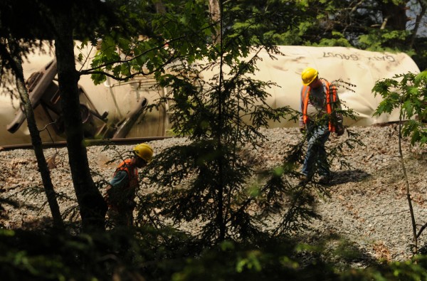 Pan Am Railways personnel work to repair the damaged rails on Saturday, May 26, 2012 near the Orrington-Bucksport town line after four tanker cars derailed on Friday sending two of the tankers into the Penobscot River. Pan Am Railways personnel work to repair the damaged rails on Saturday, May 26, 2012 near the Orrington-Bucksport town line after four tanker cars derailed on Friday sending two of the tankers into the Penobscot River.