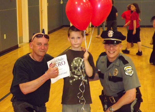 Tyler Hughes (middle) receives a hero award at Hartland Consolidated School on May 17, 2012. Hughes ran to get to attention of Darren Domonski (left) because Domonski's garage was on fire. The quick action was able to keep the garage from being leveled. Newport police Officer Chris McCrillis (right) presented the award. Tyler Hughes (middle) receives a hero award at Hartland Consolidated School on May 17, 2012. Hughes ran to get to attention of Darren Domonski (left) because Domonski's garage was on fire. The quick action was able to keep the garage from being leveled. Newport police Officer Chris McCrillis (right) presented the award.