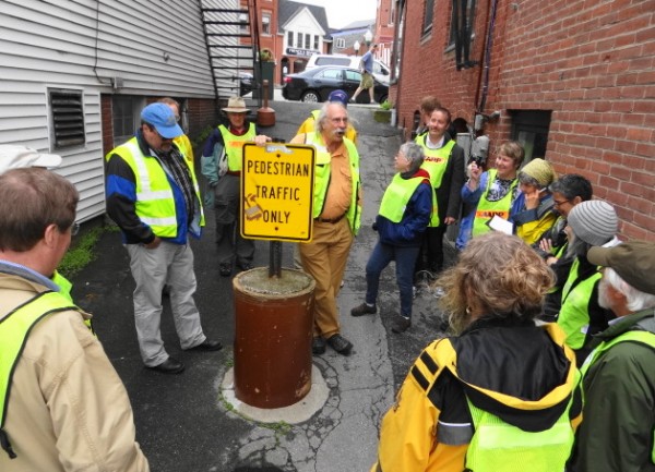 Dan Burden (leaning on sign), a consultant with expertise in making communities pedestrian friendly, pauses on a walking tour of Camden on Tuesday in an alley that leads from the town's harbor to its Main Street. Dan Burden (leaning on sign), a consultant with expertise in making communities pedestrian friendly, pauses on a walking tour of Camden on Tuesday in an alley that leads from the town's harbor to its Main Street.