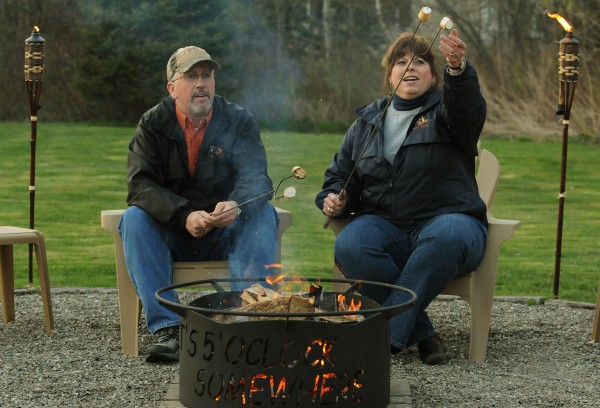 Fred and Monica Patterson toast smores over a fire in one of their custom-designed fire rings in their backyard in Brewer on Monday, April 30, 2012. Fred and Monica Patterson toast smores over a fire in one of their custom-designed fire rings in their backyard in Brewer on Monday, April 30, 2012.