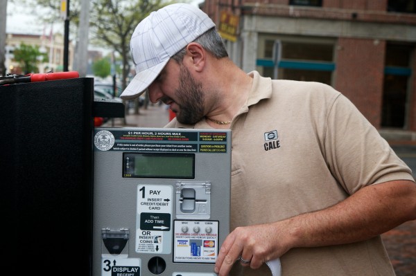 Dan Culliton of Cale America installs a new solar-powered parking meter on Commercial Street in Portland that accepts credit cards Monday morning May 14, 2012. Dan Culliton of Cale America installs a new solar-powered parking meter on Commercial Street in Portland that accepts credit cards Monday morning May 14, 2012.