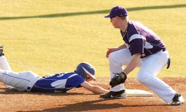Hermon's (1) Jarod Cox slides back to first base ahead of the tag from John Bapst's (14) Max Andrews in third-inning action at Husson College in Bangor Thursday. Hermon's (1) Jarod Cox slides back to first base ahead of the tag from John Bapst's (14) Max Andrews in third-inning action at Husson College in Bangor Thursday.