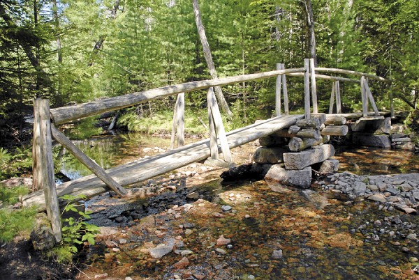 The Asticou Trail crosses Little Harbor Brook in Acadia National Park on a quaint cedar-log footbridge. The Asticou Trail crosses Little Harbor Brook in Acadia National Park on a quaint cedar-log footbridge.